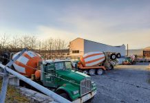 Op-Ed: The Next Seattle City Attorney Should Prioritize Wage Theft Prosecutions A gravel lot with three concrete mixer trucks.
