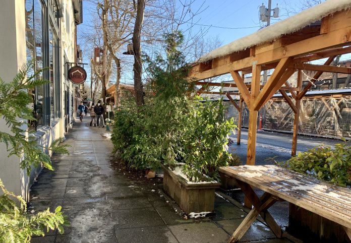 A photo of an outdoor dining area with plants.