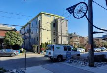 Harrell Considering Easing Micro Housing Restrictions A four story building includes simple small balconies and a yellow and gray exterior.