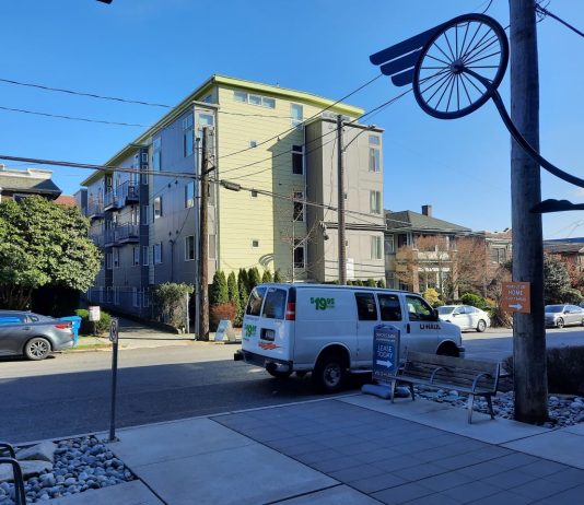 Harrell Considering Easing Micro Housing Restrictions A four story building includes simple small balconies and a yellow and gray exterior.