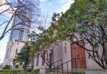 Catholic Church Property Sale Sets Stage for 1,300 Carbon-Neutral Homes in First Hill A stone building with buses in front of it.