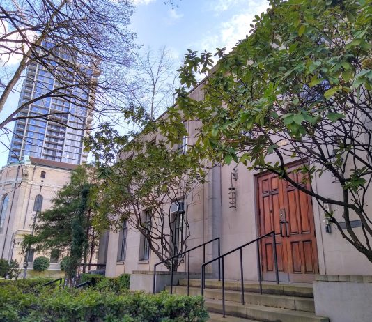 Catholic Church Property Sale Sets Stage for 1,300 Carbon-Neutral Homes in First Hill A stone building with buses in front of it.