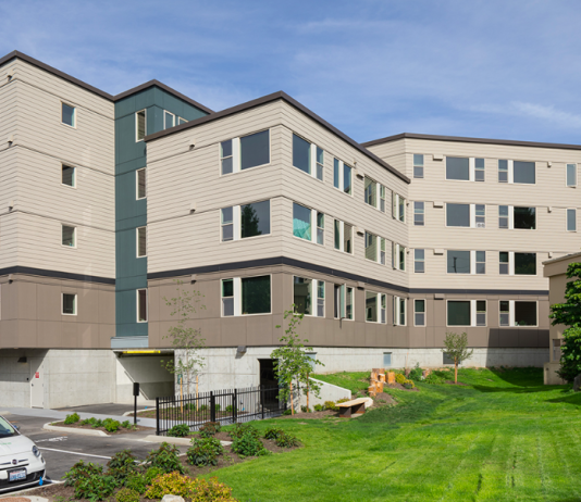 Bellevue Council Update: Juneteenth Holiday, Regional Affordable Housing Funds, and Eviction Resolution A view of a an apartment building in front of a green lawn.