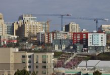 Op-Ed: Regional Workforce Housing Initiative Can Create Affordable Homes Near Jobs A photo of a city skyline with cranes.