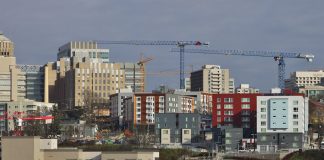 A photo of a city skyline with cranes.