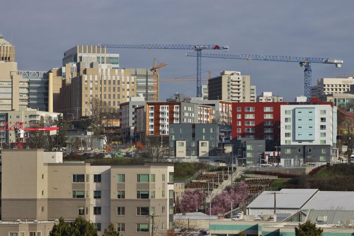 A photo of a city skyline with cranes.