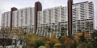 A photo of tower style housing with lots of plants