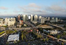 Bellevue Had a Very Busy and Productive 2022 A photo of a city with light rail under construction, streets, and tall modern buildings in the distance