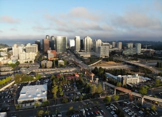 Bellevue Had a Very Busy and Productive 2022 A photo of a city with light rail under construction, streets, and tall modern buildings in the distance