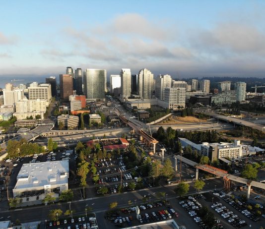 Explore Bellevue’s Wilburton Light Rail Station Area on Foot and By Bike A photo of a city with light rail under construction, streets, and tall modern buildings in the distance