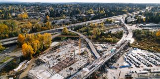 Trees have their fall colors near the track pulling into Downtown Lynnwood Station.