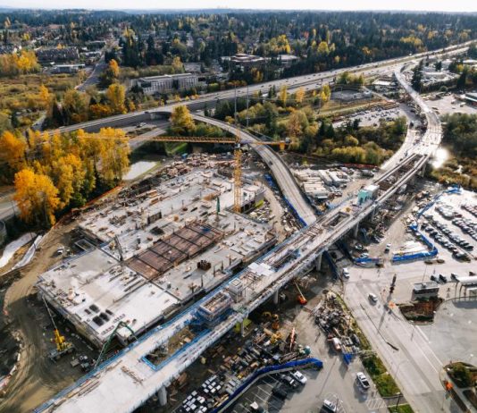 Build Light Rail In-Road Instead of Demolishing Housing, Balducci Urges Sound Transit Trees have their fall colors near the track pulling into Downtown Lynnwood Station.