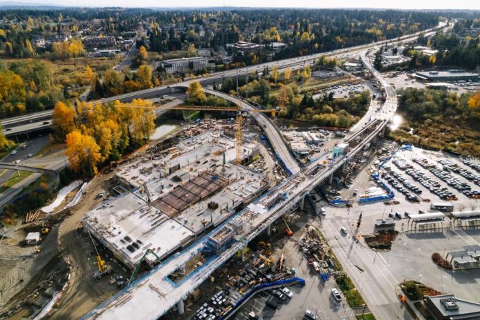 Trees have their fall colors near the track pulling into Downtown Lynnwood Station.