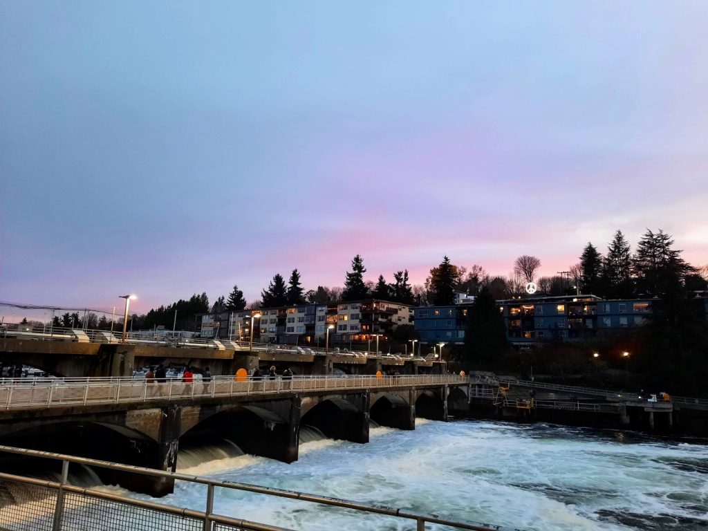 At sundown, the horizon takes on a purplish hue over Magnolia. The water is turbulent coming out of the Ballard Locks.