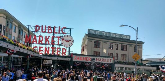More than a 100 market-goers near the Pike Street entrance to Pike Place Market.