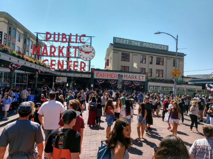 Pike Place Market summer crowd _20190720 More than a 100 market-goers near the Pike Street entrance to Pike Place Market.