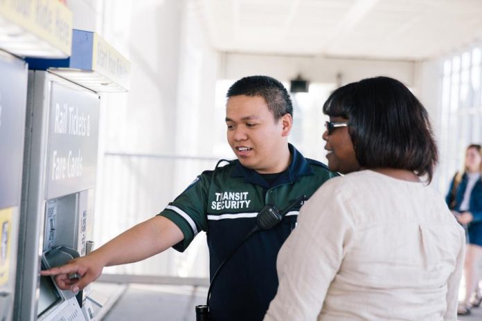 Sound Transit security helps rider with ticket machine The rider pictured is a middle-aged Black woman.