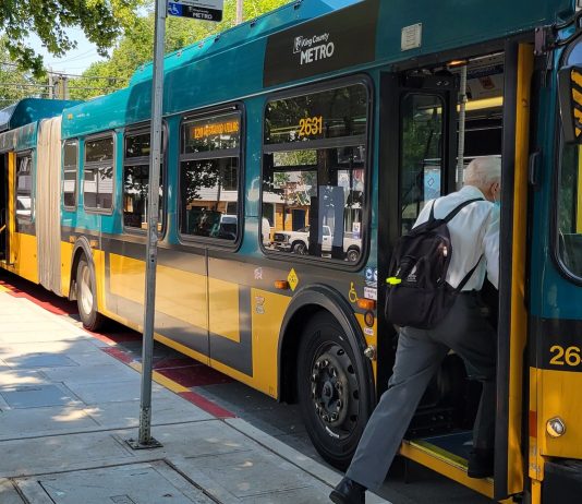 Your Transit Trips Are Free This Weekend, Let’s Celebrate! A man board an articulated bus.