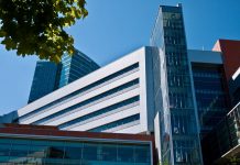 Bellevue Council Update: Supporting Retail, Fostering Cross-Cultural Connections, and Rules on Remote Participation A photo of a large modern building with a leafy tree branch in front of it.