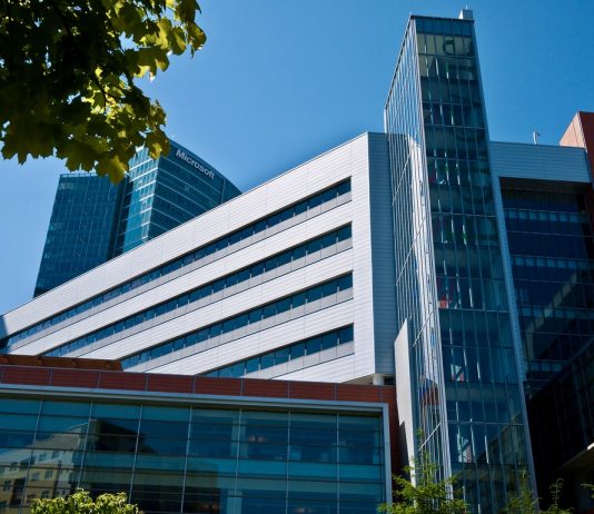 Bellevue Council Update: Supporting Retail, Fostering Cross-Cultural Connections, and Rules on Remote Participation A photo of a large modern building with a leafy tree branch in front of it.