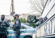 Op-Ed: New SPOG Contract Will Kneecap Hiring (at Least of Cops We Want) Three officers standing around a squad car