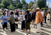 Housing Notes: Amazon Invests in Affordable Housing, Social Housing Goes to Ballot, JumpStart Tax Wins Legal Challenge a photo of a group of people standing and talking in the sun