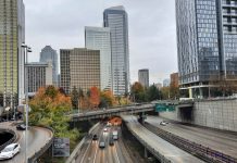 Ridehailing Sees Bigger Ridership Dip than Transit in Seattle I-t trench with skyscapers and overpasses in the background.
