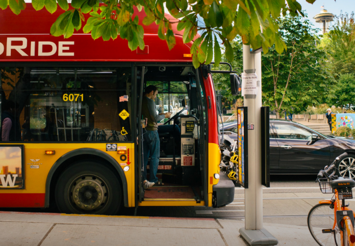 A man boards a rapid ride bus in Seattle