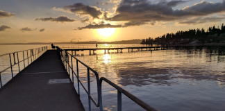 a photo of a pier at sunset