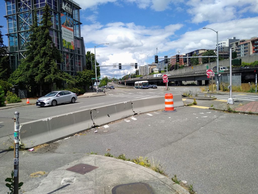 A photo showing a business intersection and the REI flagship building.