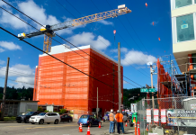 Housing Abundance and Affordability Social Hour with Tech 4 Housing A construction crane over a building under construction with another building under construction across the street and workers standing between them.