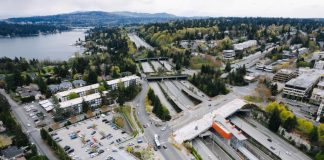 Mercer Island's light rail station, in the median of I-90, being constructed. Parking lots and low density development is visible on the periphery