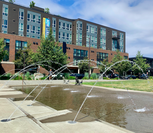 Breathing Life into Bellevue’s Spring District A photo of a fountain with an apartment building behind it.