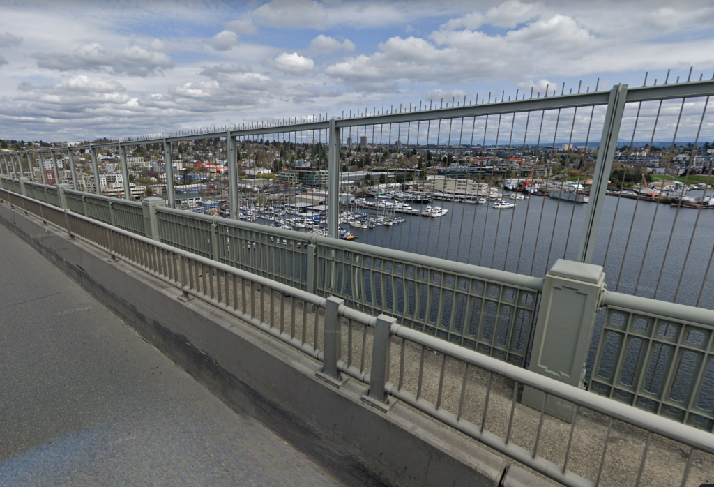 View from Aurora Ave N bridge deck of the waking space with low railing on the traffic side and a higher railing on the water side