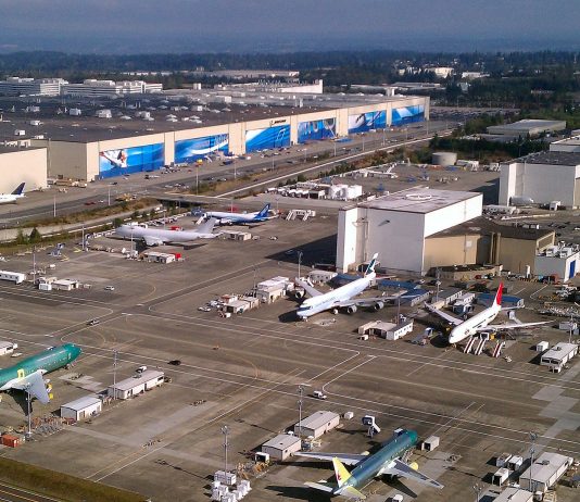 Snohomish County Leadership Group Squashes Alternatives to Paine Field Light Rail Routing An aerial photo of Boeing's sprawling Everett manufacturing plan with planes sitting on the tarmac.
