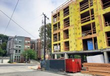 Editorial: Seattle Should Not Pass Transportation Impact Fees A five story building with yellow insulation before siding is added.