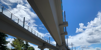 Curving, parallel concrete overpasses against a blue sky.