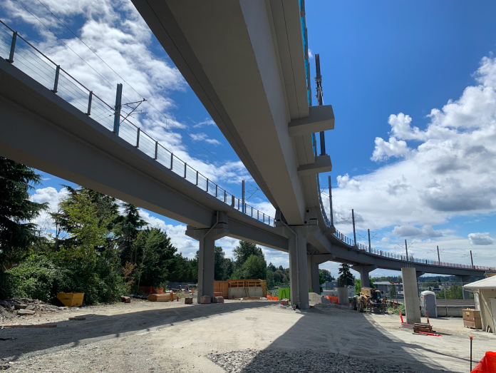 Curving, parallel concrete overpasses against a blue sky.