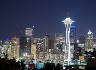 Puget Sound Agencies Offer Fare-Free Transit on New Year’s Eve Illuminated Space Needle in front of a city of lit windows with a darkening sky.