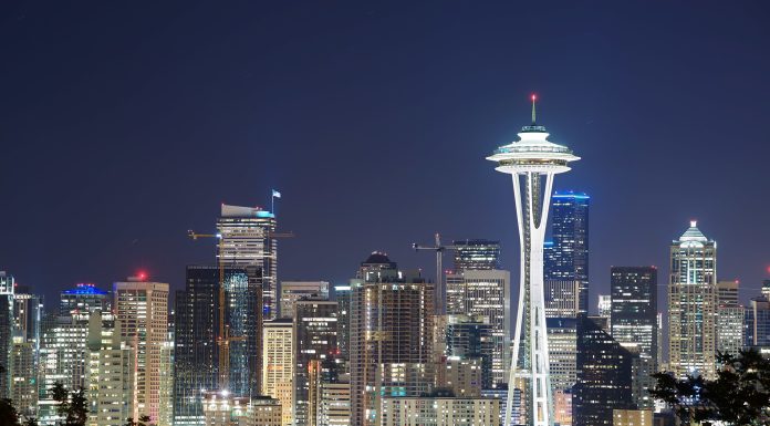 Puget Sound Agencies Offer Fare-Free Transit on New Year’s Eve Illuminated Space Needle in front of a city of lit windows with a darkening sky.