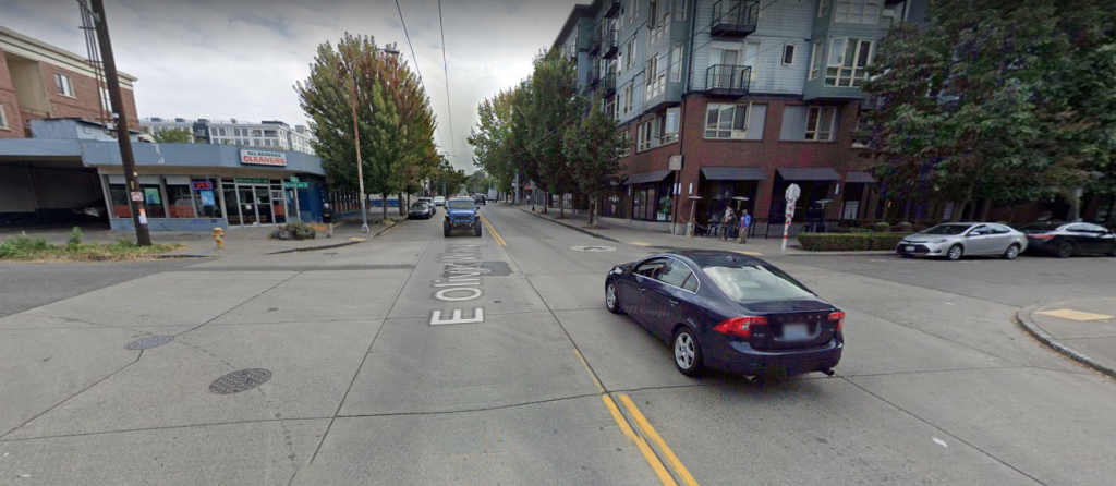 Crossing in a dense neighborhood at Harvard and Olive with no crosswalk marked and vehicles clearly not stopping