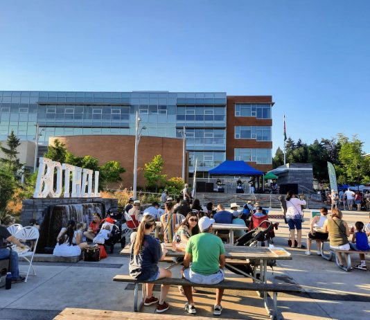 Rising Star Candidates Beyond Seattle People using outdoor seating during a Bothell festival.