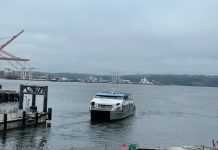 West Seattle Water Taxi To Maintain Summer Service Levels Year-Round Elliott Bay view of a water taxi arriving at Colman Dock downtown Seattle on a very cloudy day.