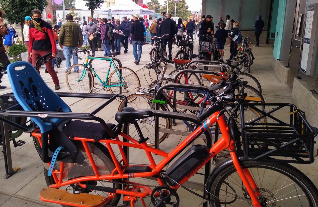 A slate of bikes, including an electric cargo bike, at the University of Washington Station