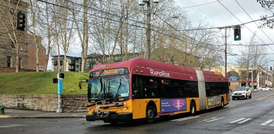 An articulated RapidRide branded bus runs as Route 49 in Capitol Hill.