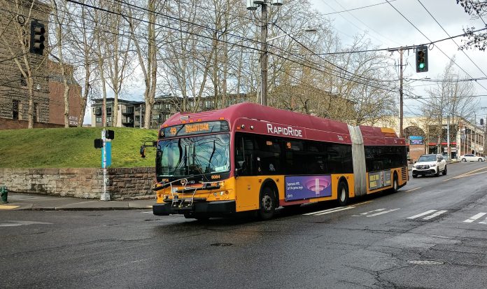 An articulated RapidRide branded bus runs as Route 49 in Capitol Hill.