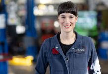 Five Takeaways from the 2022 Election A young dark-haired woman in her blue autobody shop overalls.