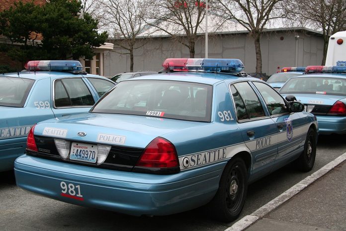 A light blue SPD police cruiser in a parking lot.