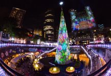 Seattle Needs a Festive Outdoor Christmas Market Brightly colored Christmas lights and a Christmas tree in the center of a transit station.
