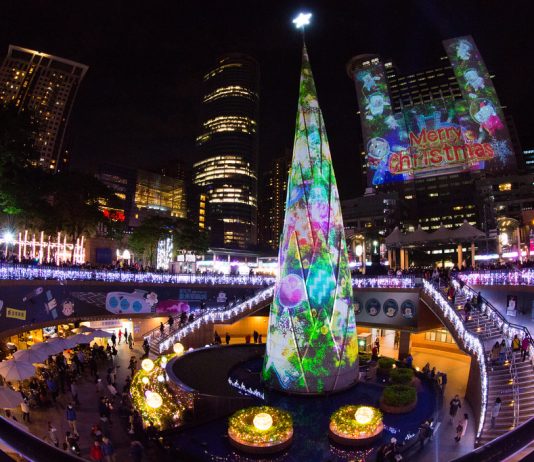 Seattle Needs a Festive Outdoor Christmas Market Brightly colored Christmas lights and a Christmas tree in the center of a transit station.